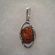 Pendentif boule d'ambre entoure de lire